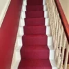 Large Diamond Flame Red flatweave runner on white wooden staircase