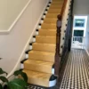 Flatweave Herringbone stair runner in Marigold installed on monochrome staircase