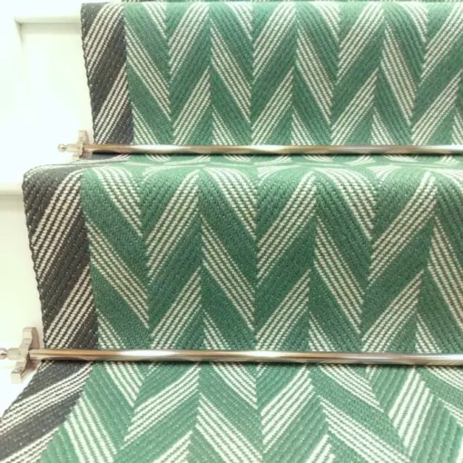 Green Herringbone stair runner with dark green woven border on white stairs