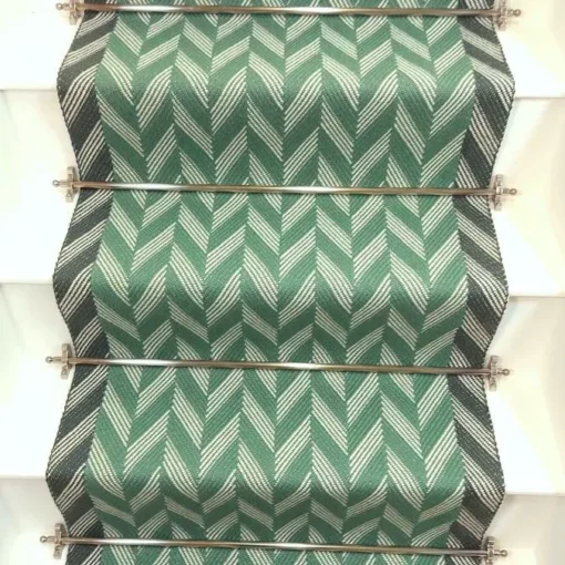 Green Herringbone stair runner with dark green woven border on white stairs