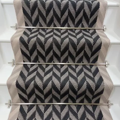 Black and white Herringbone Stair Runner with a grey woven border on white stairs