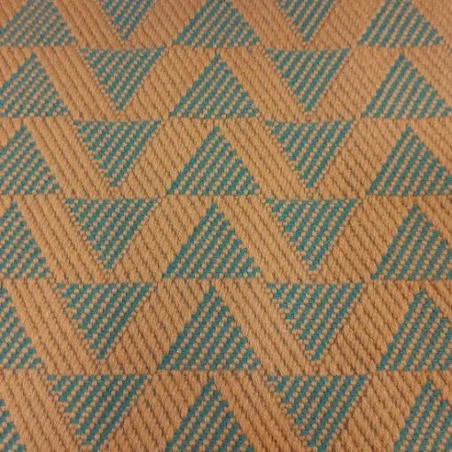 Cinnamon-coloured stair runner with green triangle pattern on white wooden stairs